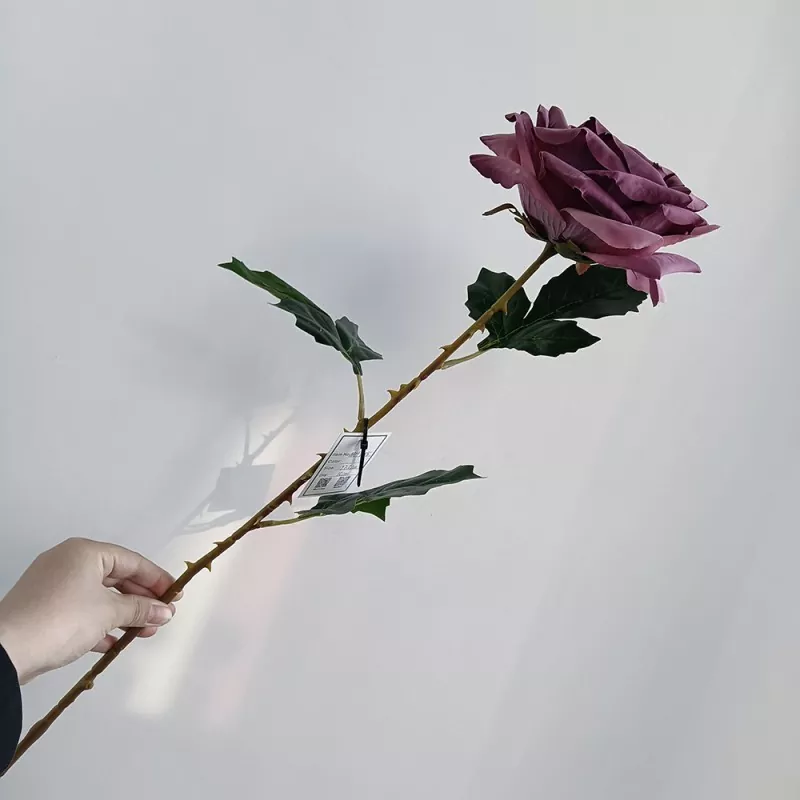 single artificial rose in red with realistic texture